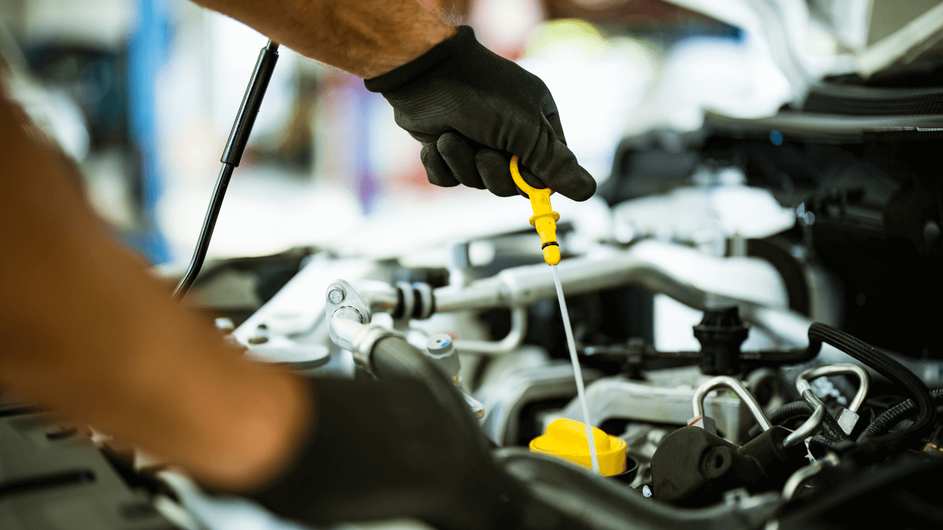 professional auto repair technitian performing routine maintenance on vehicle.